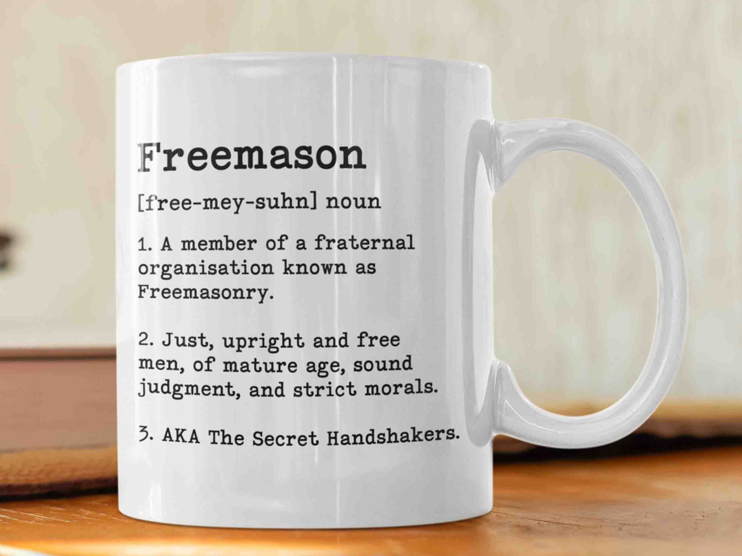 The "Freemason Dictionary" mug is a unique and humorous way to start your morning. This 11oz ceramic mug features a dictionary-style layout listing three definitions of the role of a Freemason, including a funny alternative name. Perfect for any Freemason, and its high-quality craftsmanship and eye-catching design will be appreciated by any Masonic enthusiasts. Order yours today!