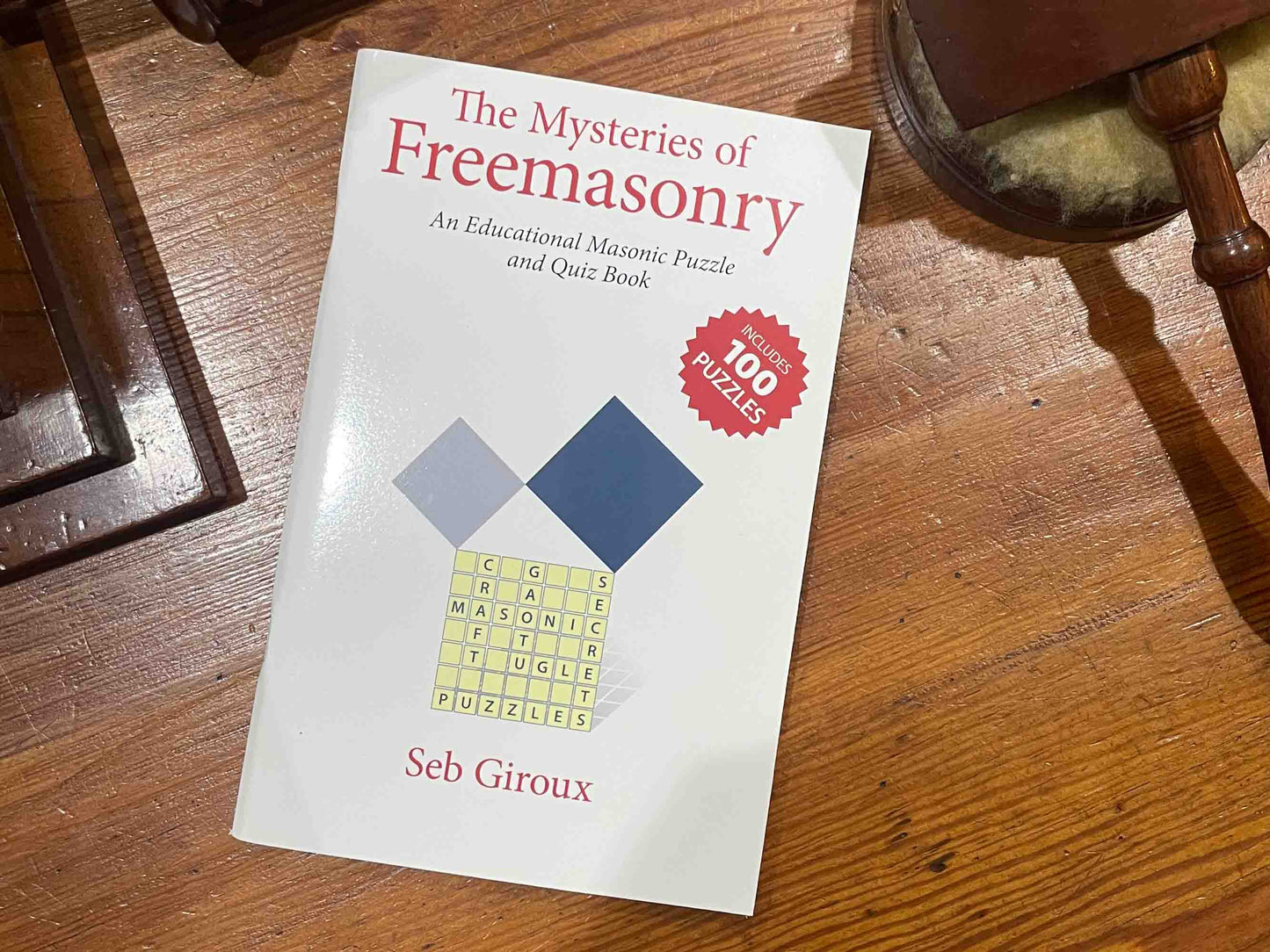 A selection of puzzles and quizzes from the book 'The Mysteries of Masonry', challenging readers to uncover the truth and secrets of the Freemasons, including whether they built Washington D.C and if they are connected to the Illuminati.