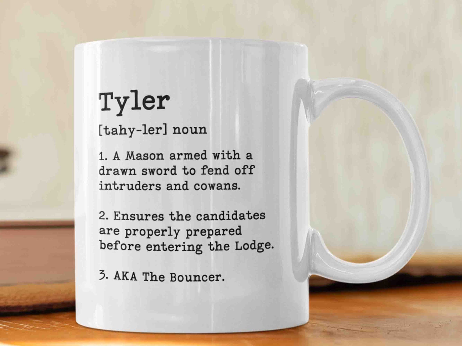 The "Tyler Dictionary" mug is a unique and humorous way to start your morning. This 11oz ceramic mug features a dictionary-style layout listing three definitions of the role of a Tyler, including a funny alternative name. Perfect for any Freemason, and its high-quality craftsmanship and eye-catching design will be appreciated by any Masonic enthusiasts. Order yours today!